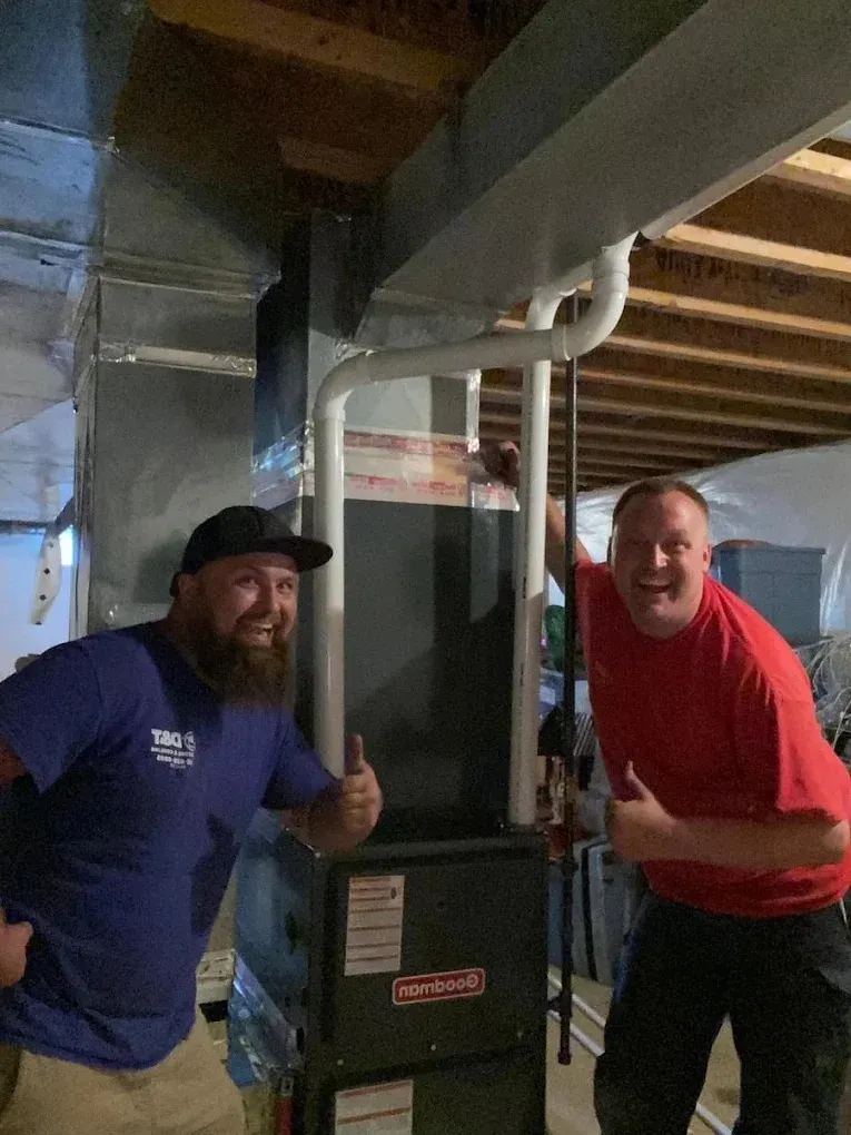 Essential Spring Home Maintenance Tasks HVAC technician performing maintenance on a unit, emphasizing best practices for care